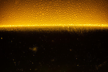 Beer Close Up,Close up in foam and bubbles of beer on black background
