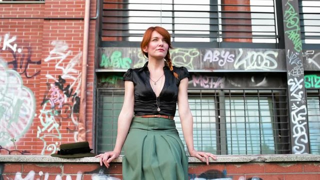 Adult gingerhead woman outdoor posing smiling looking over &ndash; peaceful, serene, carefree concept