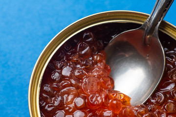 caviar in tin can on blue background