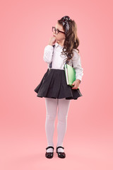 thoughtful little girl isolated on pink background