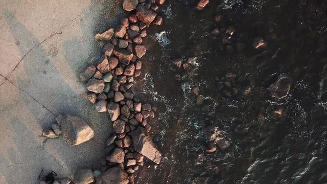 4K summer late afternoon aerial video of Santalahti Baltic Sea Finnish Bay lagoon, pine tree forest beach with red granite boulders, lone island beach near Kotka, Finland Suomi, northern Europe