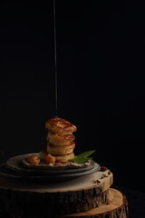 delicious pancakes on a black background in rustic style