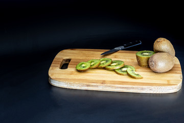 sliced kiwi on a cutting board front view
