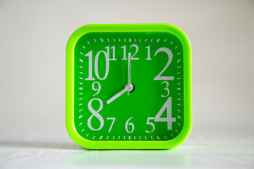 green clock on white background