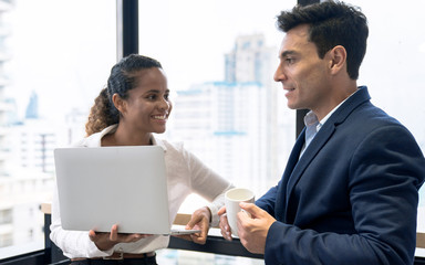Colleagues talk while standing at the office window, Communication with colleagues, Business people.