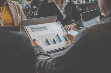 Business people are looking at the product sales report