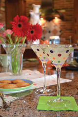 Cocktails in polka-dotted martini glasses with cookies and flowers