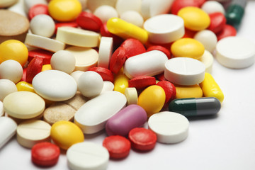 Different colorful tablets at white background