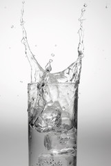 An ice cube falling into a glass of pure water.
