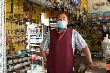 Entrepreneur in his business working with face masks