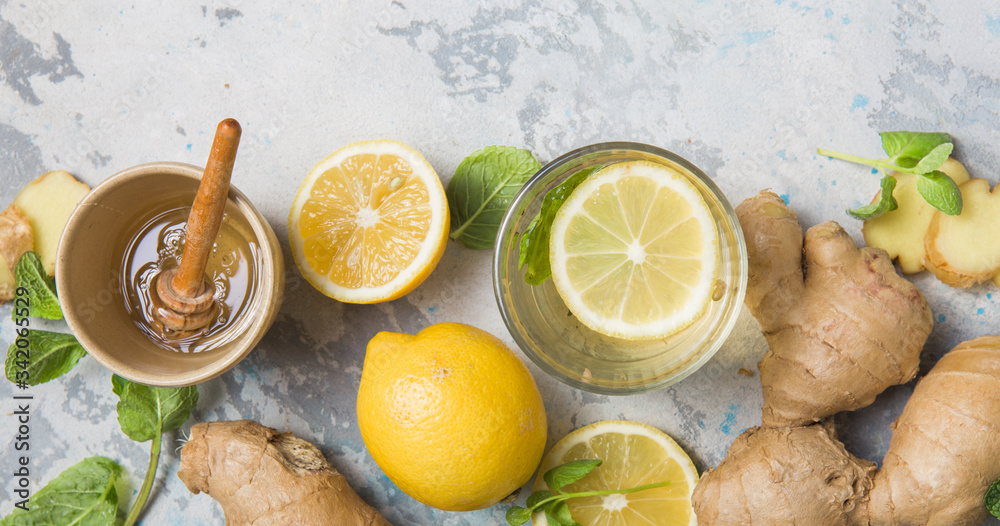 Wall mural Lemon and ginger tea with honey. Healthy ingredients against cold. Top view image  with copy space. get rid of toxins and boost.