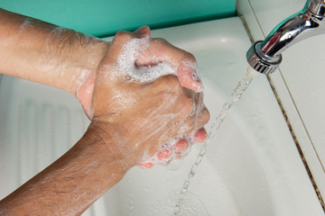 Fototapeta premium person sanitizing hands