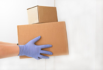courier delivering boxes. hands holding box with food. contactless delivering concept. keep social distance and stay home during quarantine. contact free and safe shopping