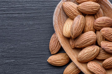 Organic almond nuts as background, top view. Healthy snack. For vegetarians.Space for text