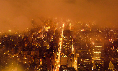 Foggy view of the Empire State Building by night.