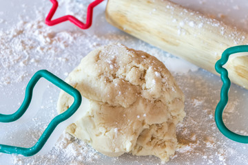 Cookie cutters, dough, and rolling pin