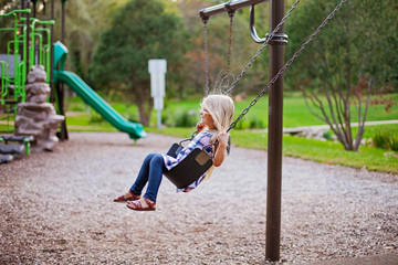 Happy little girl having fun on playground