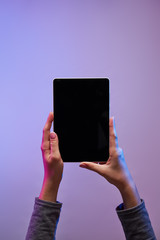 Close-up of man's hand with phone and blank black screen on empty background