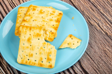 Cracker cookies isolated on wooden background.