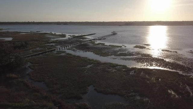 Coastal scenery at sunset with dock and intracoastal waterway