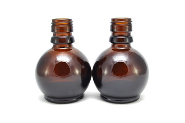 Brown glass bottle on a white background close up
