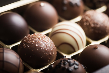 Mixed luxury dark and milk chocolate truffles. Assorted delicious handmade chocolate pralines in a...