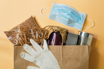 Food delivery, Donation, coronavirus. Buckwheat, pasta, canned food, mask and rubber gloves. 