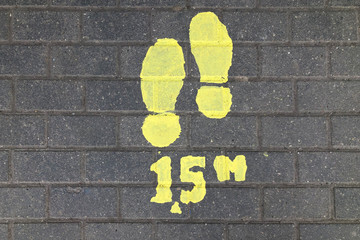 Markings on the ground advising to keep social distance 1.5 meters