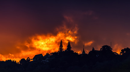 Beautiful sunset and orange sky, red clouds outdoor with the silhouetted Was Phra That Doi Suthep Temple, Important landmarks of Chiang Mai in Thailand.