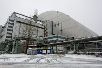 New Safe Confinement above remains of reactor 4 and old sarcophagus at Chernobyl nuclear power...