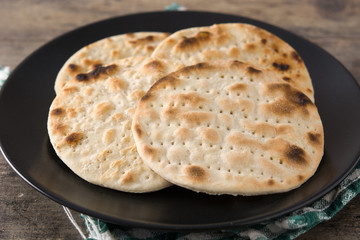 Handmade matzah for Jewish Passover on wooden table
