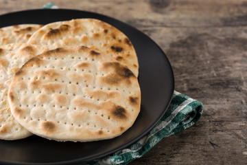 Handmade matzah for Jewish Passover on wooden table