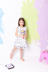 Little cute girl with instruments for renovation apartment room isolated on white background.