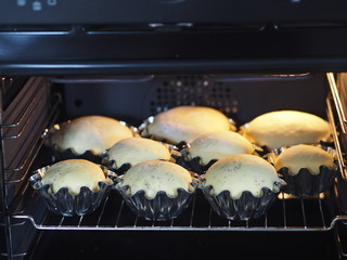 Buns are baked in baking pans in the kitchen oven.Homemade cake.