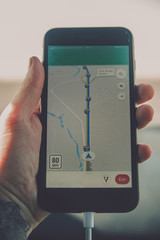 iPhone in a hand with gps map