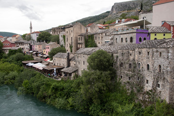 Views of Mostar with colored facades and roofs on the banks of the Neretva River in Bosnia, Europe.