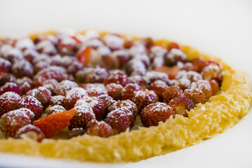 Delicious strawberry pie with sugar powder on top, isolated on white background. Concept of homemade cooking, baking, fruit pastry recipe.