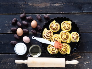 The view from the top.Pastry background.Raw rolls with chocolate filling on a dark wooden table.