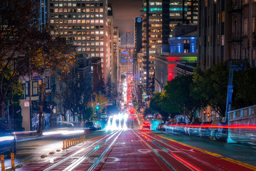 San Francisco's famous California Street at night, with a view of the Bay Bridge, during a rainy night - Holiday Season 2019