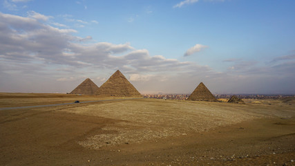 Fototapeta na wymiar Pyramids of Giza with Giza city view background