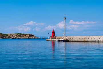 View of the red lighthouse in the port of Giglio island (Grosseto, Tuscany, Italy).