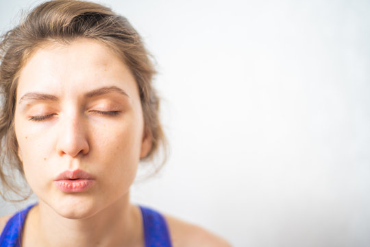 A woman performs breathing exercises during a fitness break. Cleansing the mind and meditation for a healthy mind and body