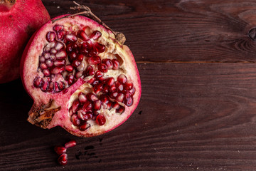 pomegranate on a wooden board on a black background