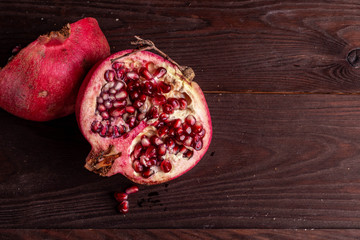 pomegranate on a wooden board on a black background