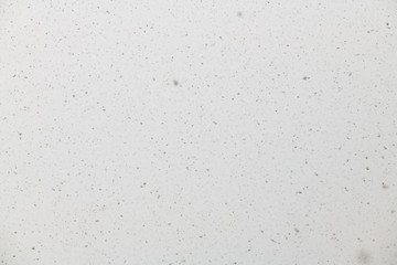 White blurred background with small snowflakes