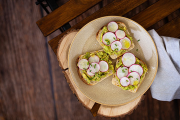 Healthy sandwich with avocado and radishes