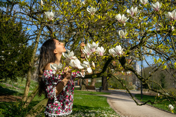 Beautiful middle east girl enjoying spring time with flower dress