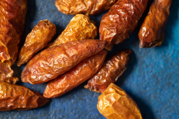 Detail of dried cayenne to add spice to food. Blue dark background