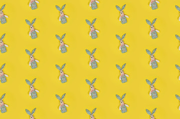 Seamless colorful Happy Easter pattern with cute rabbits on bright yellow background