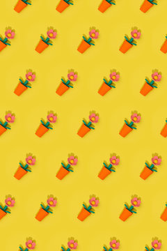 Seamless Easter spring pattern with flowers in red pots arranged in rows on yellow background